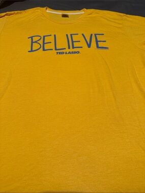 Homage BELIEVE Ted Lasso Graphic Tee - Yellow with Blue Print